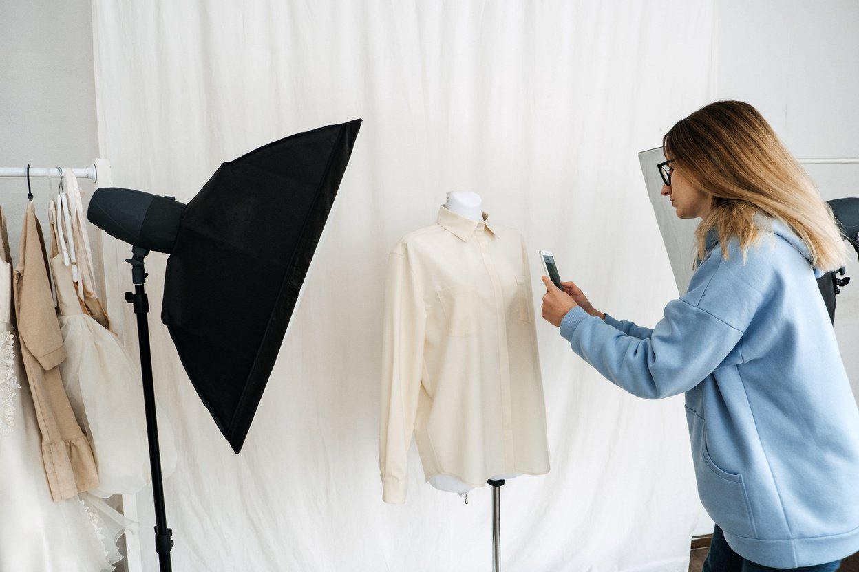 Young Woman Taking Closeup Photos of Clothes